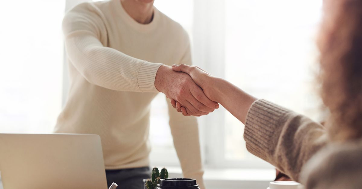 A friendly handshake at a door after a tutoring arrangement conversation.
