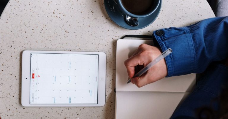 When a calendar link is not enough: a phone showing a booking link beside a paper lesson planner.